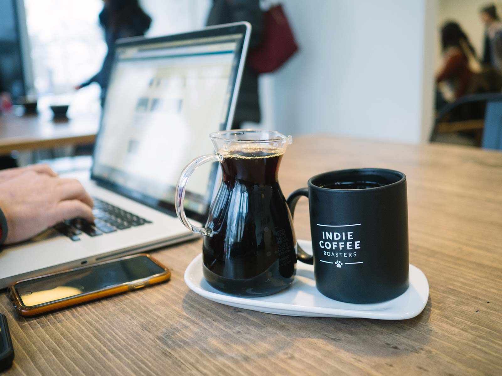 Indie Coffee Roasters - carafe of coffee next to a laptop