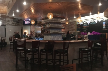 The bar in the center of everything at Louie's Wine Dive & Ripple Kitchen.
