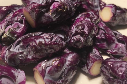 Jewel-tone purple Brussels sprouts dazzle when paired with black walnuts, bacon and a touch of maple syrup
